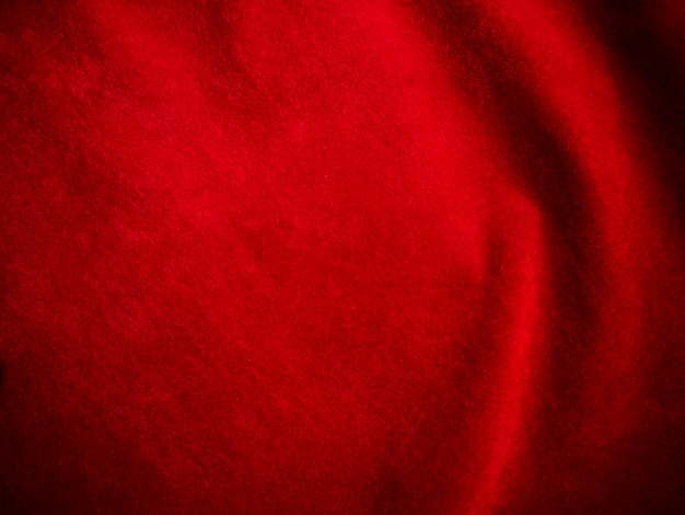 Foto textura de tela de terciopelo rojo oscuro utilizada como fondo fondo de tela rojo oscuro vacío de material textil suave y liso hay espacio para texto