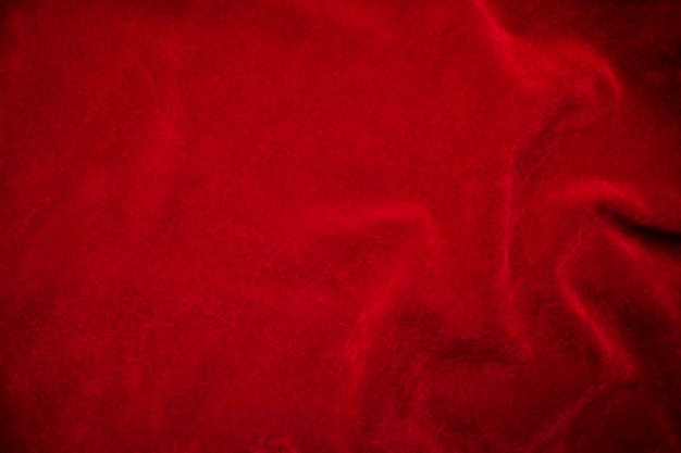 Foto textura de tela de terciopelo rojo utilizada como fondo fondo de tela roja de material textil suave y liso hay espacio para textx9