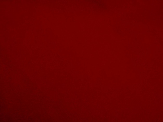 Foto textura de tela de terciopelo rojo utilizada como fondo fondo de tela roja vacía de material textil suave y liso hay espacio para texto
