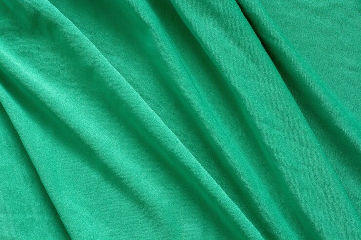 Foto textura de tela verde con hermosas ondas diagonales