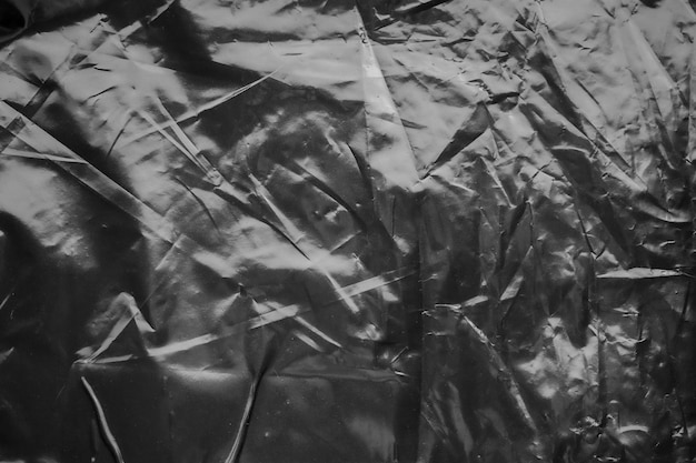 Textura transparente da sobreposição do envoltório do saco de plástico no fundo preto