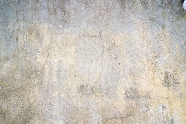 Textura de la vieja pared de hormigón gris para el fondo Óxido dañado en la superficie de la pared de hormigón para el fondo Textura áspera en la forma áspera de la pared gris debido a la capa de pintura descascarada debido a la lluvia