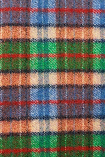 Foto textura xadrez de lã cobertura de lã de alpaca dobrada macia e quente tiro macro de textura xadrez de lã verde e laranja