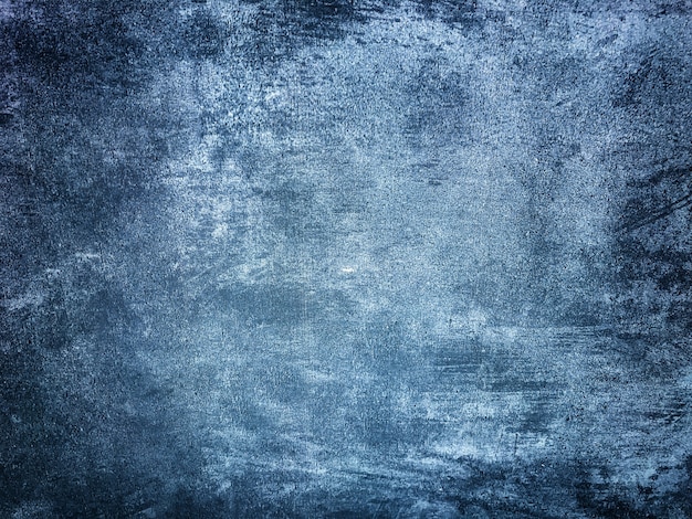 Textura de yeso azul marino decorativo imitando la vieja pared descascarada. Fondo de piedra agrietada obsoleta con patrón. Estructura de muro de cemento con viñeta oscura.
