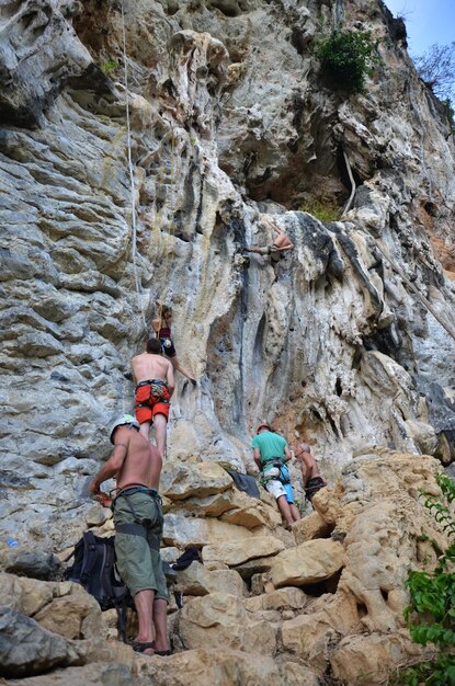 Thailändische Bergsteiger und ausländische Bergsteigersportler klettern am Dragon Crest Precipice Mountain und den Railay Stone Cliffs und reisen, besuchen Sie, entspannen Sie sich in der Ao Nang Beach Bay in Krabi Thailand
