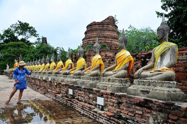 Thailändische Frau trägt Mauhom-Kleidungsporträt mit Buddha-Statue von Wat Yai Chaimongkol in Ayutthaya Thailand