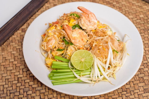 Thailändisches traditionelles Essen Pad Thai Nudeln mit Garnelen in Schüssel auf Holztisch