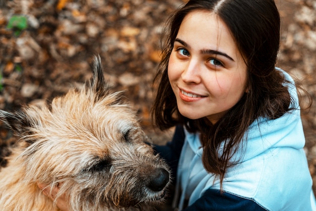 Tiertraining. Ein freiwilliges Mädchen geht mit einem Hund aus einem Tierheim. Mädchen mit einem Hund im Herbstpark. Gehen Sie mit dem Hund. Sich um die Tiere kümmern.