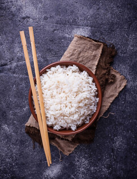 Tigela de arroz cozido e pauzinhos