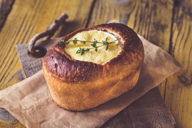 Tigela de pão de camembert na mesa de madeira