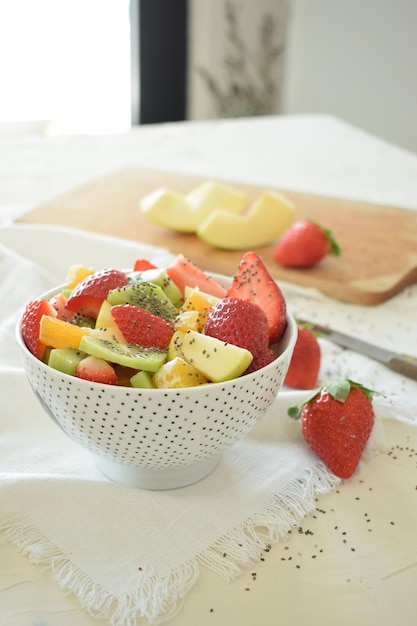Tigela de salada de frutas frescas, kiwi, maçãs, laranjas.