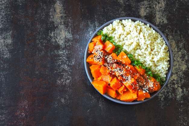 Tigela vegana com bulgur e abóbora. Comida vegetariana saudável em uma tigela.