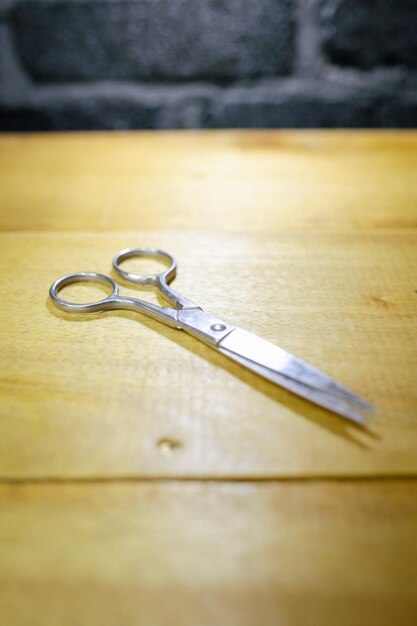 Tijeras de peluquero profesional elegante corte de pelo sobre fondo de madera