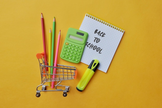 Útiles escolares en el carrito de la compra, comprando útiles escolares.