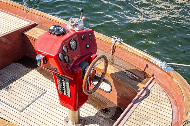 Timón de madera de un bote pequeño viejo rojo