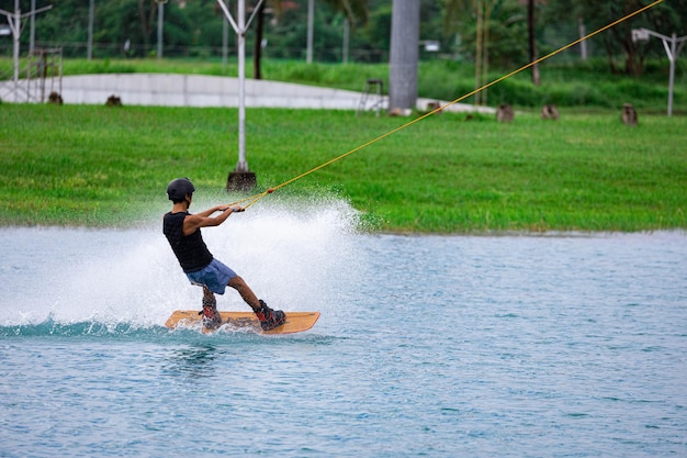 Foto un tipo haciendo wakeboard en un lago artificial