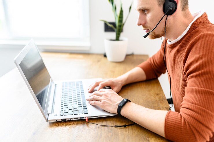 Foto el tipo usa auriculares de manos libres para trabajar desde casa.