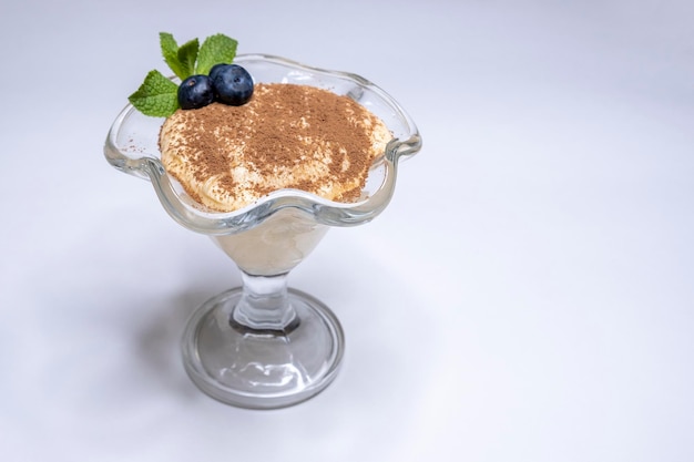 Tiramisú en una vista superior de vidrio Postre espolvoreado con cacao Pastel de hojaldre de crema y cacao Menú del restaurante Cocinar en casa Espacio de copia Lugar para texto