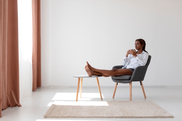 Foto tiro completo mujer sentada en una silla