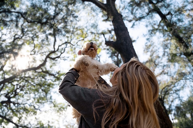 Tiro medio mujer sosteniendo perro