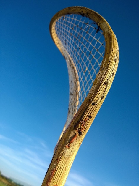 Tiro vertical de una raqueta de bádminton vintage bajo el cielo azul
