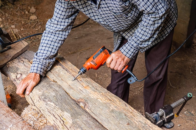 Tischler arbeitet, um Holz zu bohren