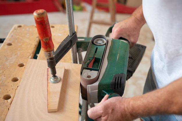 Tischler, der in der Werkstatt am Holzhandwerk arbeitet, um Baumaterial oder Holzmöbel herzustellen.