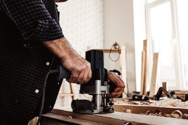 Tischler schneidet Holz mit elektrischer Stichsäge aus nächster Nähe