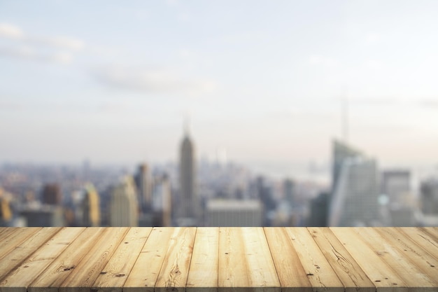 Tischplatte aus Holz stirbt mit verschwommenem Blick auf die Stadt auf Hintergrundvorlage