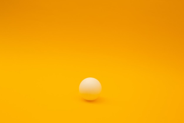 Tischtennisball auf orangefarbenem Hintergrund