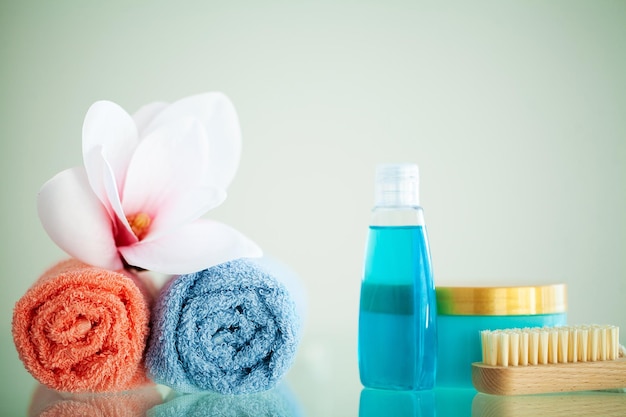 Toallas de colores y orquídeas en una mesa blanca con espacio para copiar en el fondo del baño