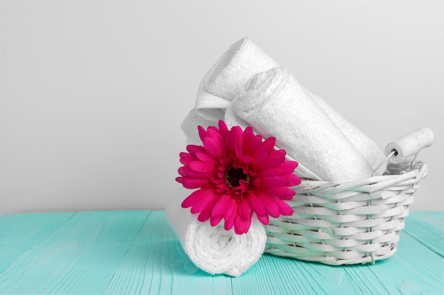 Foto toallas limpias y suaves con flores en la mesa de madera