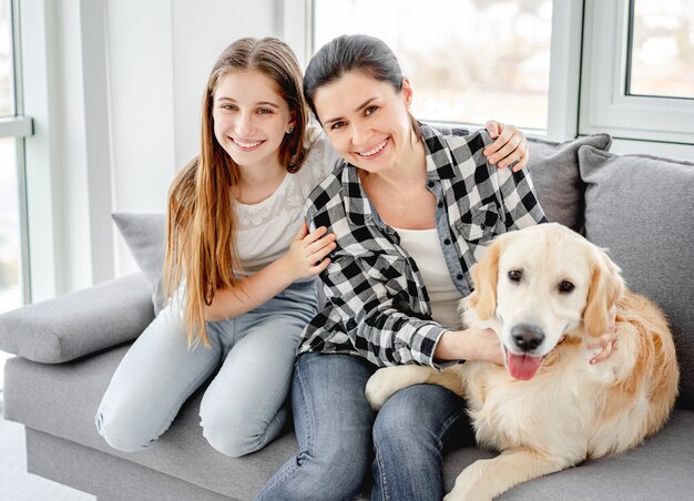 Tochter und Mutter neben Hund