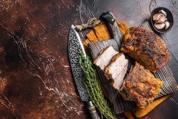 Tocino de panceta de cerdo asado con corteza sobre una tabla de madera Fondo oscuro Vista superior Espacio de copia