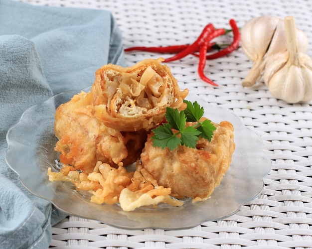 Tofu branco recheado frito com legumes picados ou Tahu Isi (Gehu Pedas), lanche popular tradicional da Indonésia, isolado em marrom com espaço de cópia para texto