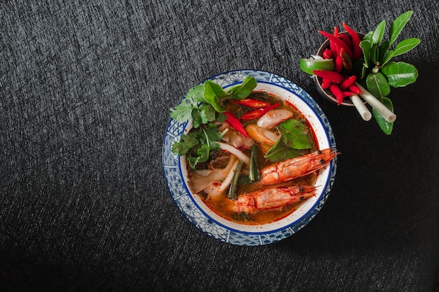 Tom Yam kung Sopa tailandesa picante con camarones en la oscuridad.