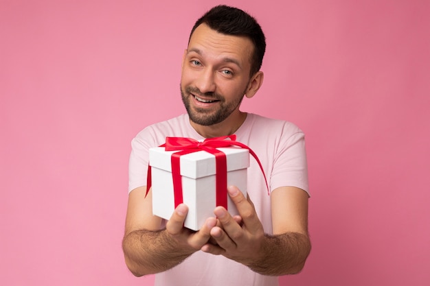 Toma de la foto del guapo joven sin afeitar morena positiva