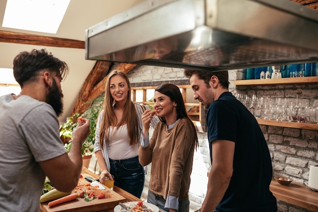 Toma recortada de un grupo de amigos desayunando en la cocina