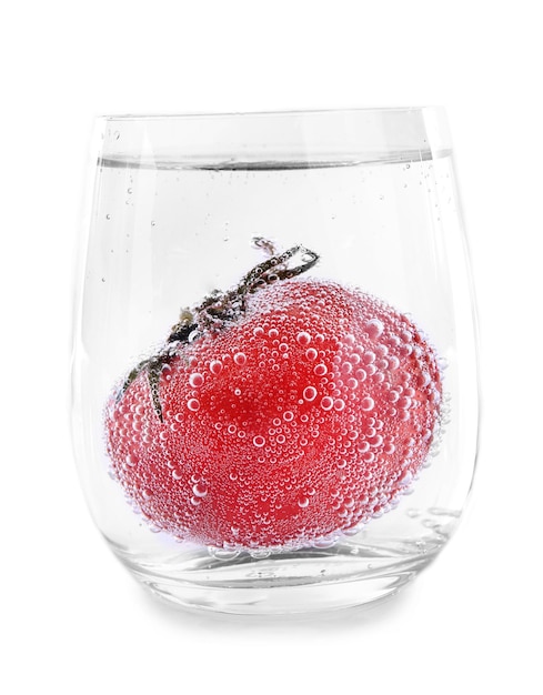 Tomate em copo de água isolado em branco