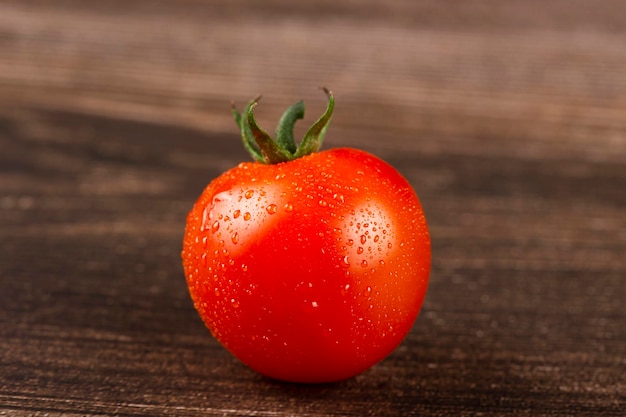 Tomate fresco maduro en la mesa de madera