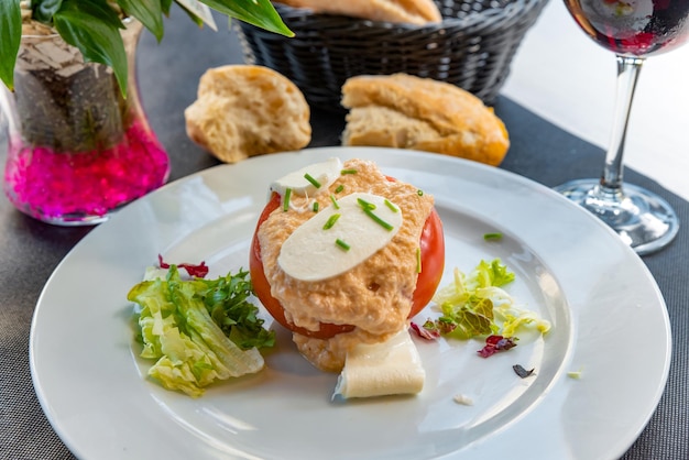 Tomate recheado com queijo no prato