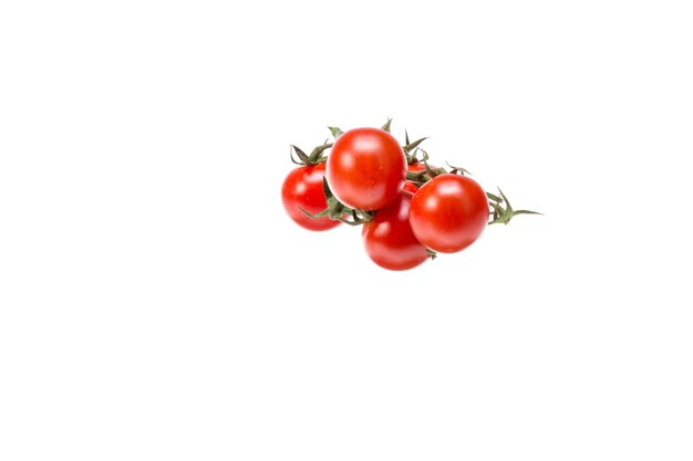 Foto tomates de cereza rojos contra un fondo blanco