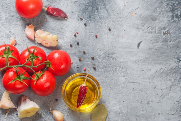 Tomates cherry en una rama, aceite, perejil y especias