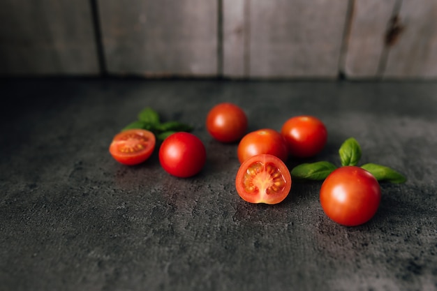 Tomates cherry rojos con albahaca verde.