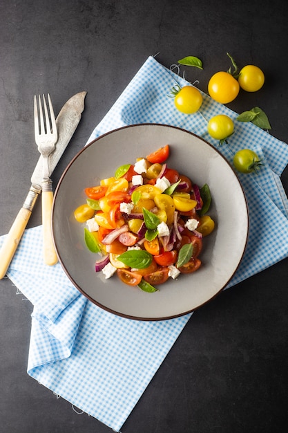 Tomates coloridos e salada de manjericão em um prato