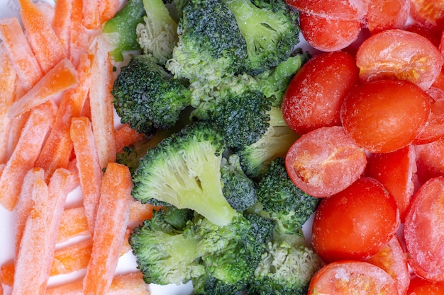 Tomates congelados, zanahorias y brócoli de cerca, vista superior