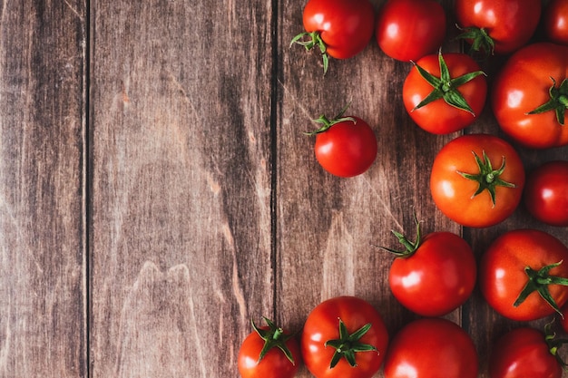 Tomates en la mesa de madera vieja verduras de tomate rojo fresco planas con espacio de copia