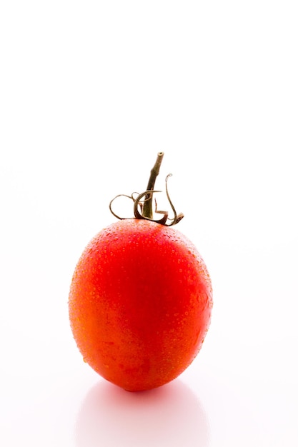 Tomates Roma orgánicos sobre fondo blanco.