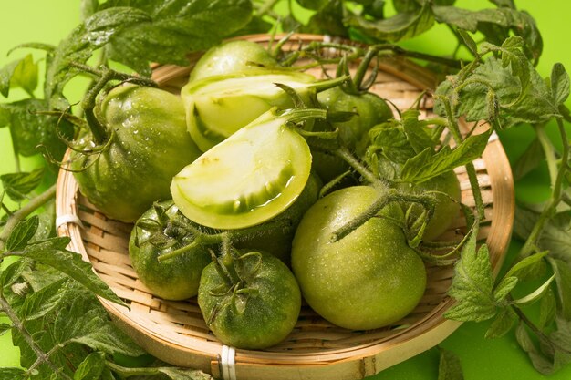 Tomates verdes frescos sobre un fondo sólido