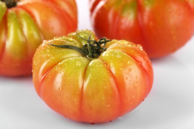 Tomates verdes con gotas de agua de cerca